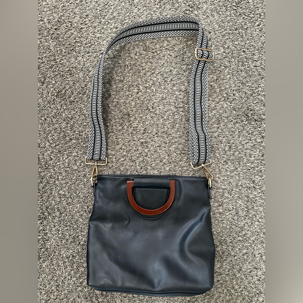 Black Leather Crossbody Bag with Brown Handle and Patterned Strap
